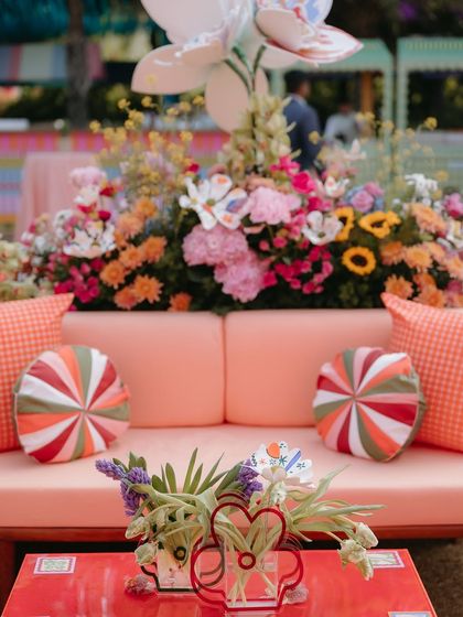 A close-up of the vibrant lounge seating, with candy-cane style cushions and playful decor elements that contributed to the carnival atmosphere.