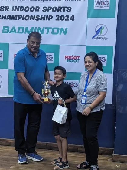 Ajinkya Desai receiving his first-place trophy at the SR Indoor Sports Championship. A proud moment for him and our academy.