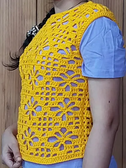 A side view of the Argalia Bloom Top, highlighting its comfortable fit and how the floral filet pattern looks from different angles.