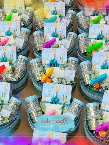 Celebrate a baby's first Holi with our adorable giveaways. These small baskets are filled with child-safe colors, fun pichkaris, and sweet treats, all presented with a cute hot-air balloon themed card.