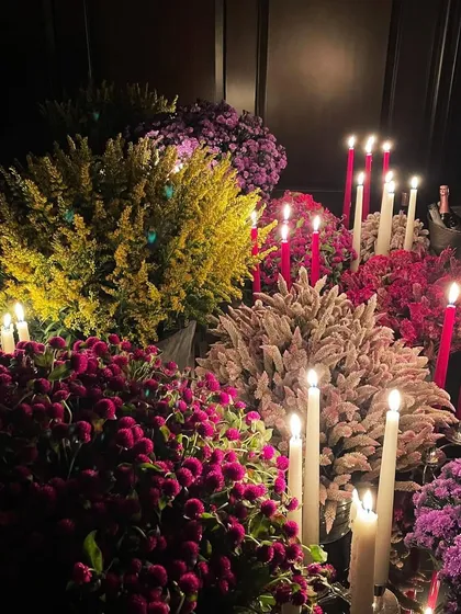 I believe in living in luxury, and that includes bringing beautiful floral experiences into your home. This display of colorful flowers and candles creates an elaborate and one-of-a-kind tablescape.