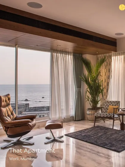'That Apartment' in Worli showcases seamless transitions between spaces. Here, a comfortable leather armchair is perfectly positioned to take in the sea view, demonstrating our focus on creating functional and beautiful moments within a home.