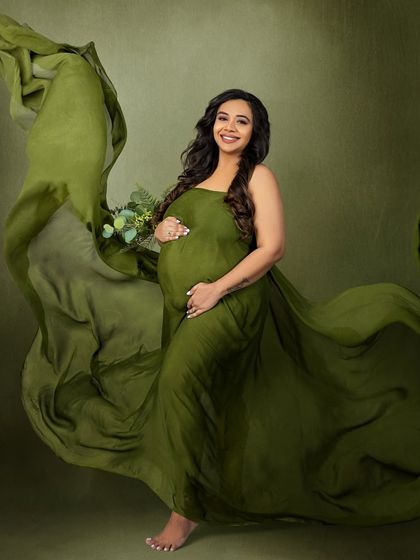 A dynamic shot with the green fabric flowing, creating a sense of freedom and life.