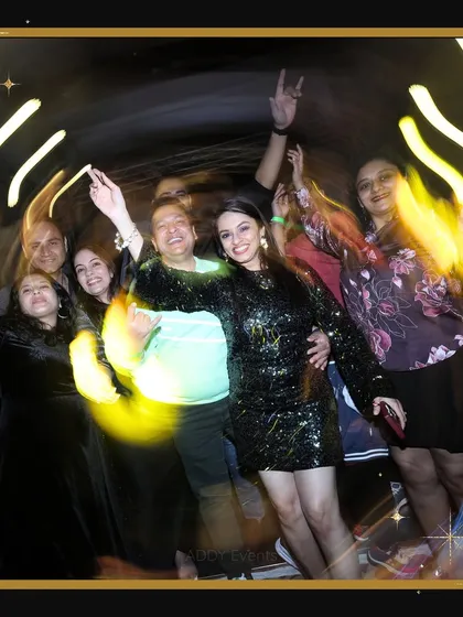 A group of guests enjoying a fun, light-trail photo effect at a New Year's Eve party. This shows how we can incorporate interactive and fun elements into our events for memorable takeaways.