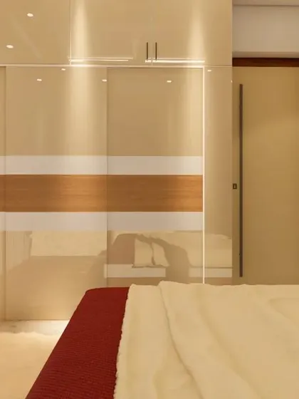 Another angle of the bedroom, showing the reflection on the glossy sliding wardrobe and how it makes the space feel larger.