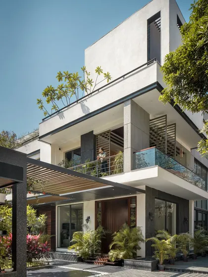 Twin Villa was designed as a home for two families, balancing shared spaces with private retreats. The architecture uses layered balconies, deep overhangs, and integrated planters to create a dynamic facade that engages with the landscape, blurring the line between inside and out.
