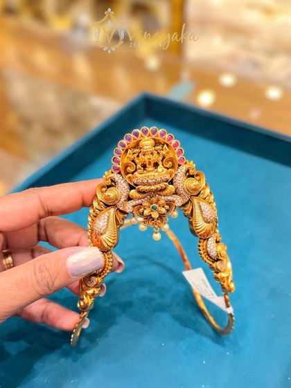 Another one of my unique bajuband designs, this one features a Goddess Lakshmi motif surrounded by peacock designs and studded with ruby-colored stones. It is adjustable and comfortable to wear.