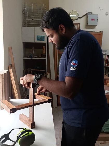 Nihal carefully assembles his planter stand. This project requires precise half-lap joints to ensure it's stable and strong.