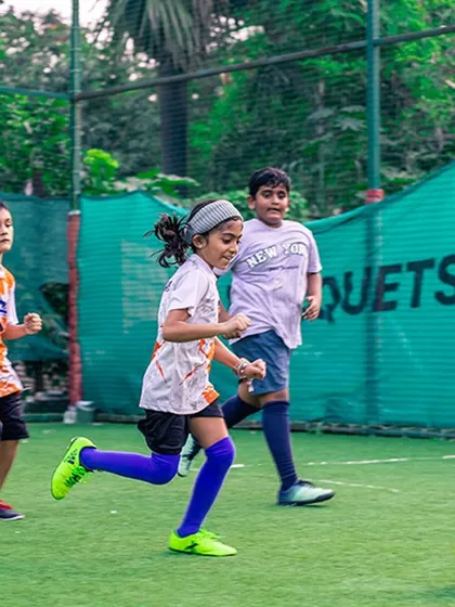 A coach guides our young football players during a training session. I emphasize building a strong foundation and a love for the game from the very first day.