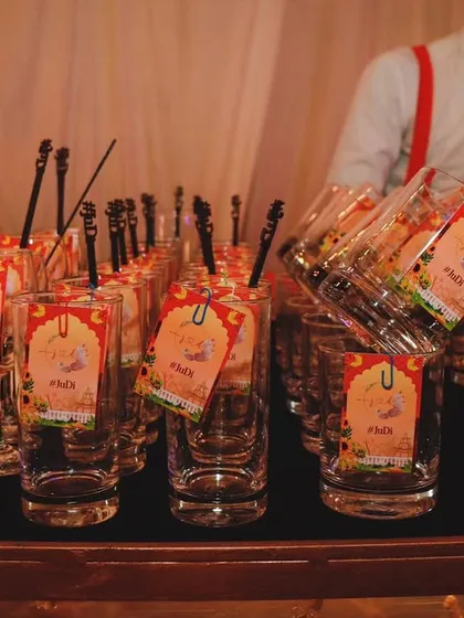 Personalized glassware ready for a welcome dinner. The custom tags with the couple's initials add a thoughtful and elegant touch to the celebration.
