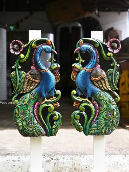 A pair of 24-inch standing peacock wall mounts, painted in brilliant blues and greens. These pieces are designed to face each other, creating a symmetrical and beautiful display.