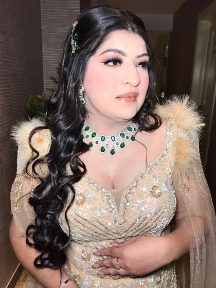 The side profile highlights her romantic curls and the sparkle of her jewelry.