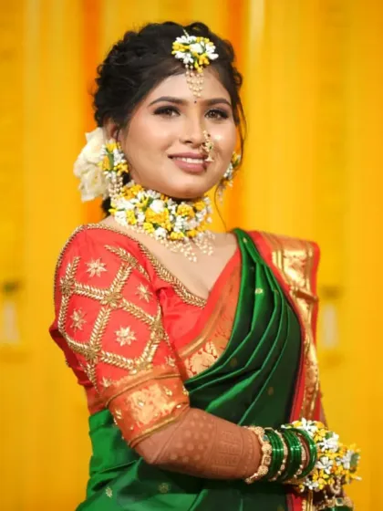 A full portrait showcasing the complete Haldi look, from the floral maang tikka to the matching bracelets.