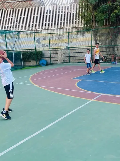 A player practices his shooting form, focusing on the fundamentals.