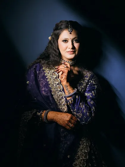 The full sangeet look, showcasing the intricate embroidery of the outfit and the elegant hairstyle.