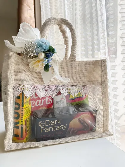Make your destination wedding guests feel welcome the moment they arrive. This custom jute welcome bag is filled with snacks, drinks, and essentials, all beautifully presented with lace detailing and a floral touch to match your wedding theme.