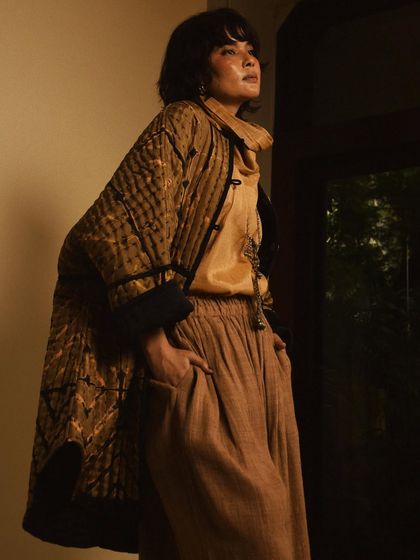 A fashion portrait for House of Wandering Silk, using shadows and a doorway to create a moody and atmospheric shot.