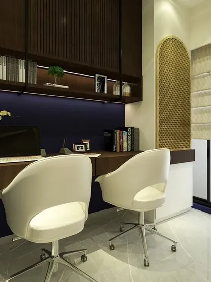 This before-and-after shows the transformation of a cluttered corner into a sophisticated dual-person workspace. The deep blue wall, warm wood tones, and integrated Mandir create a space that is both productive and peaceful.