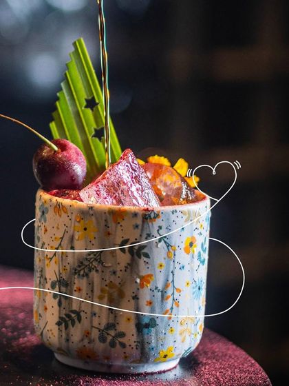 Wrapped around in love. This cocktail, with its floral ceramic cup and cherry garnish, is perfect for creating magical memories with someone special.