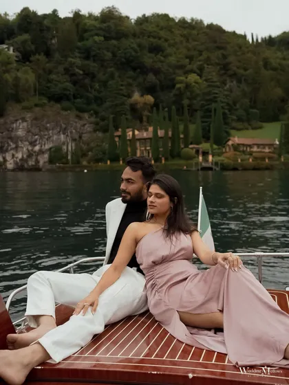 A chic portrait of Nisarg and Mansi on a classic wooden boat in Lake Como, Italy. This image combines luxury, style, and the stunning natural scenery of the Italian lakes for a truly aspirational pre-wedding shot.