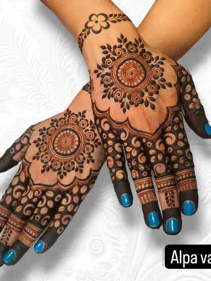 A classic backhand mandala design, beautifully complemented by the client's bright blue nail polish.