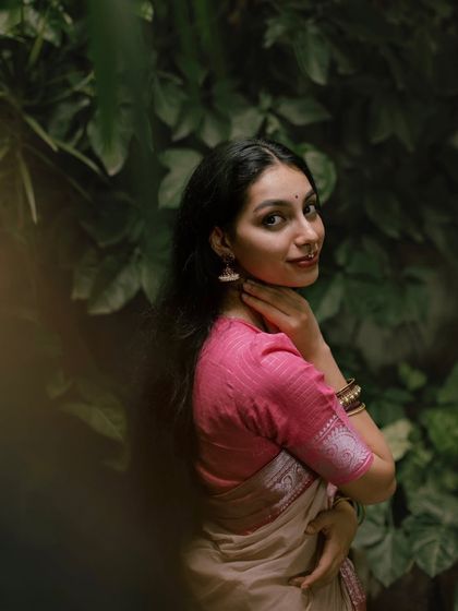 A candid portrait in a garden setting. The framing through the leaves gives it an intimate, voyeuristic feel that I find really beautiful.
