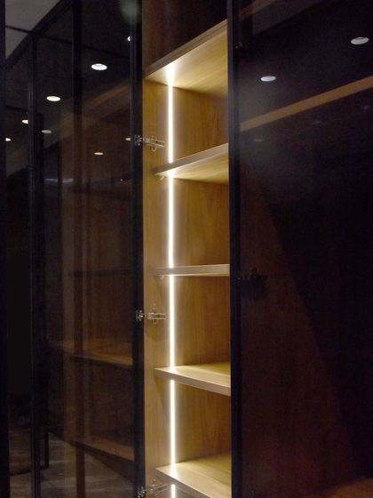 A close-up of our integrated vertical LED lighting inside a glass wardrobe. This feature not only looks sophisticated but is also practical, illuminating the entire height of the cabinet.