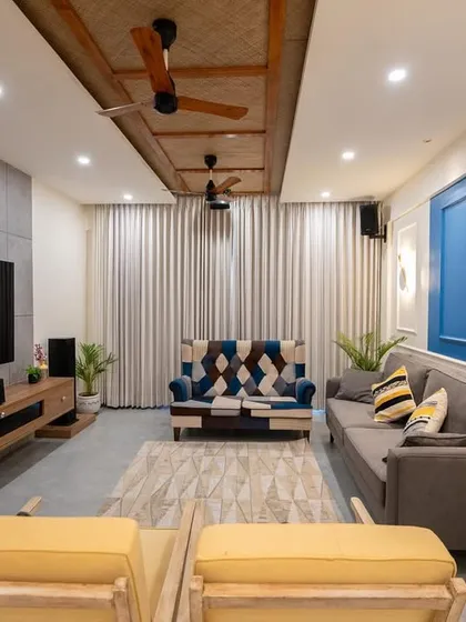 A complete view of the living area from image 16, showcasing the layout with the yellow chairs and the overall color balance.