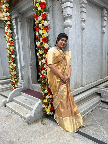 Shilpa posing by a temple entrance, her traditional attire looking perfectly in place.
