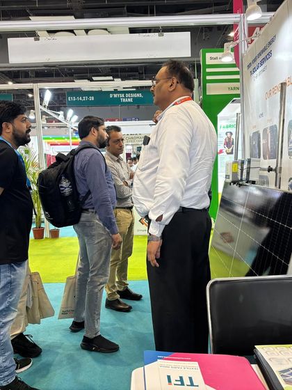 A member of our team explaining the technical specifications of a solar panel to interested visitors. We believe in educating our clients so they can make informed decisions about their energy future.