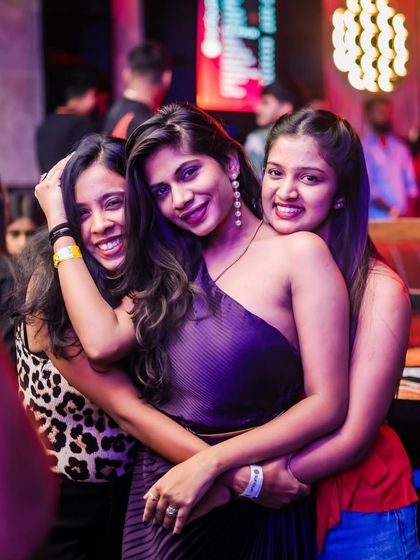 Friends hugging and smiling on the dance floor. This is the kind of positive and happy vibe I aim to create every night.