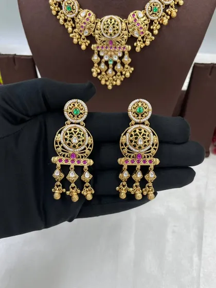 A close-up of the earrings from the antique jaali work set.