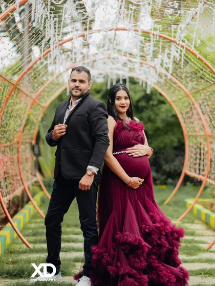 A stylish couple's portrait in a tunnel of lights, creating a magical and glamorous atmosphere.