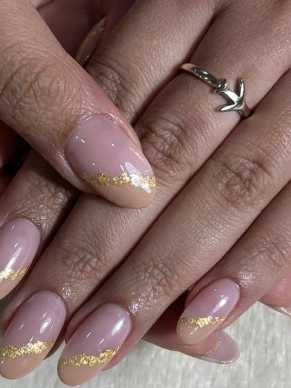 Another view of the chic foil glitter nails. The delicate gold flakes add a touch of texture and luxury to the neutral base.