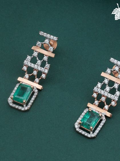 The Zarnaya earrings, designed to echo the necklace's grandeur. These pieces feature emerald-cut gemstones and a cascade of diamonds, offering a statement of pure luxury.