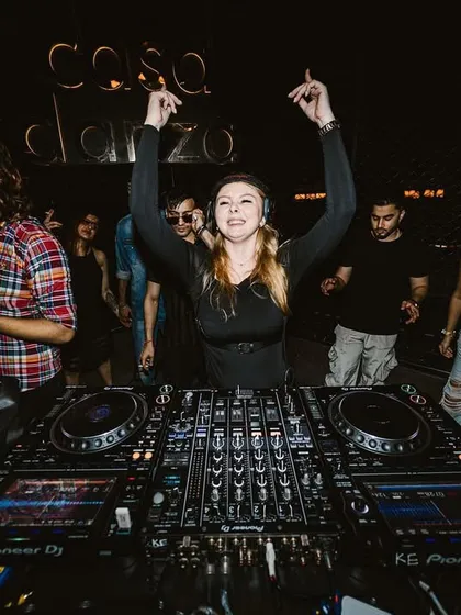 Hands in the air, celebrating a peak moment in the set with the audience.