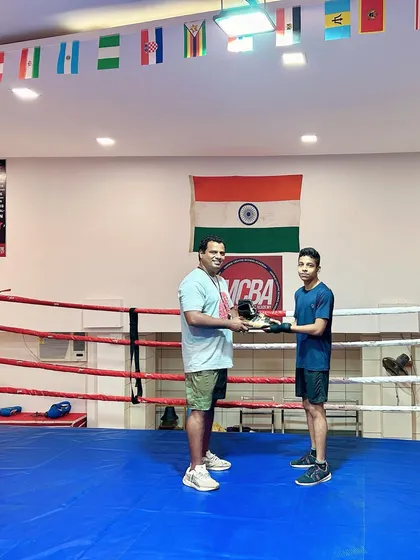 A full view of the coach and student in the ring during the gift presentation.