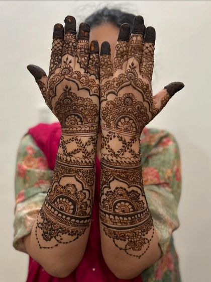 A semi-bridal design that still offers significant coverage. The patterns are dense on the hands and extend up the arm with beautiful, spaced-out traditional motifs.