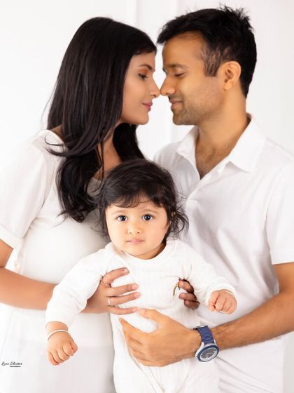 A beautiful pose showing the connection between parents, with their baby looking confidently at the camera. We capture a mix of interactions in every family session.