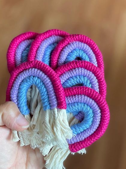 A handful of my popular rainbow keychains. The combination of pink, purple, and blue is a customer favorite.