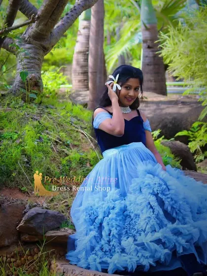 The blue ruffled gown with its velvet top looks stunning in a natural, woodland environment. The contrast between the soft tulle and the rustic background creates a beautiful, storybook feel for your maternity pictures.