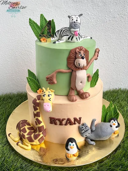 We brought the wild world of Madagascar to life with this fun, two-tiered cake. It features all the main characters like Alex the lion and Marty the zebra as playful, handmade fondant figures.