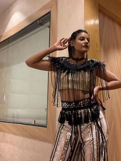 Striking a pose in my performance attire. The outfit is a key part of the storytelling, and this one was chosen to complement a fast-paced, celebratory dance routine.