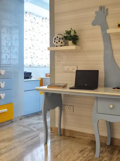 Designing for the little ones is always special. This kids' room features a custom study table with a playful giraffe element, ample storage in dual-tone cabinets, and a bright, cheerful color palette. We focus on creating spaces that are not only fun but also practical and grow with your children.