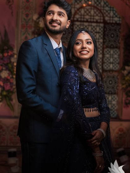 A classic reception portrait of Dr. Akshara and her groom. Her glam makeup and sparkling lehenga make for a picture-perfect moment.