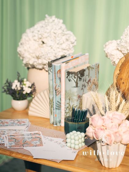 The guest message station at 'The Conservatory' baby shower, with custom stationery and elegant decor.