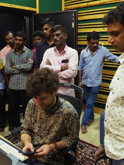 The whole crew listening back to a take with the folk percussionists. It's a team effort, and everyone's input is valued in shaping the final sound.