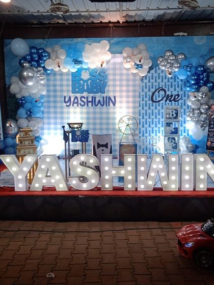 A grand Boss Baby stage with large illuminated marquee letters spelling out the birthday boy's name, Yashwin.