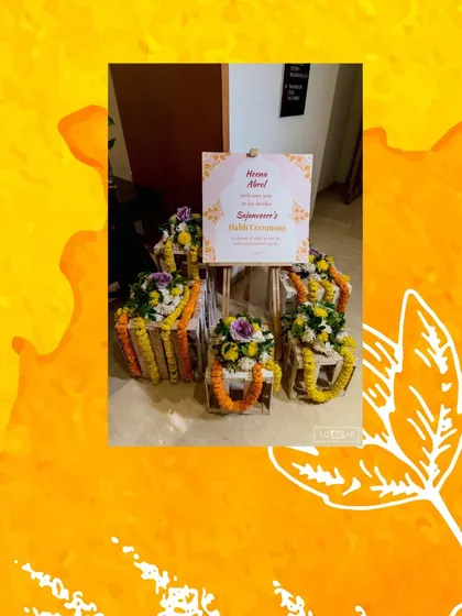 A personalized welcome sign for a Haldi ceremony, framed by beautiful marigold garlands and floral arrangements. It's a small touch that makes guests feel special from the moment they arrive.