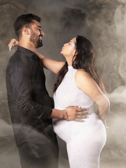 A playful and romantic pose with a smoky effect, adding a touch of drama and magic to this couple's portrait.